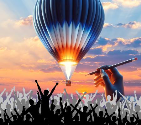 This image portrays a surreal scene with a vibrant sunset and a brightly glowing hot air balloon in the sky. Below, a crowd of silhouetted people appears to be celebrating. Above them, a giant hand holding a pencil suggests it is drawing the balloon, adding a creative and fantastical element to the scene.